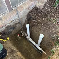 Licensed plumber in Palm Springs FL tightening a sink drain pipe